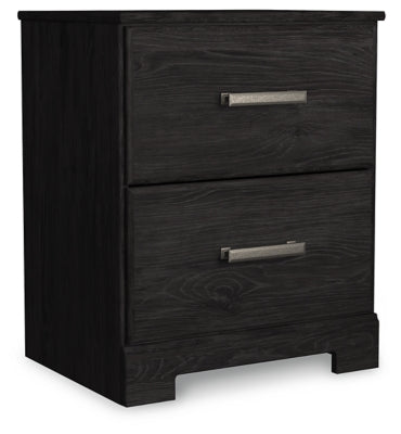 Ashley Furniture Belachime bedroom set with a modern design, including a bed frame, nightstands, and matching dresser, shown from an angled view.