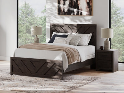 Ashley Furniture Prendonea Bed with elegant upholstered headboard and sleek frame, showcasing a modern bedroom design.