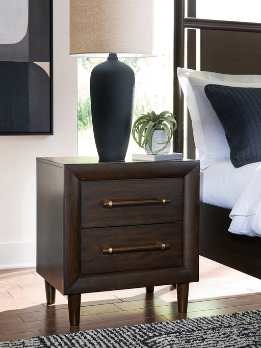 Ashley Furniture Dantenton nightstand with a sleek wood finish and modern design, featuring a single drawer and open shelf.