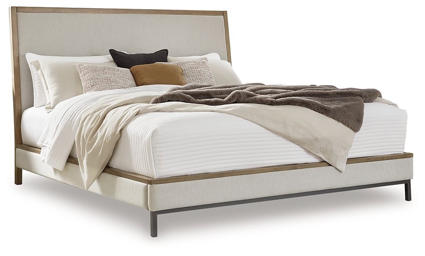 Ashley Furniture Tomtyn upholstered bed with a plush, fabric headboard and elegant design, shown in a stylish bedroom setting.