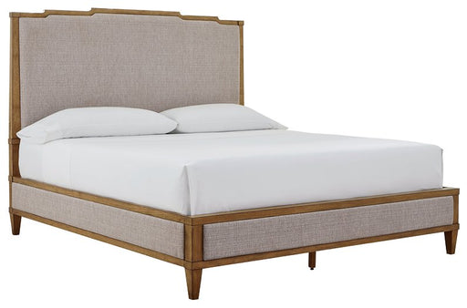 Ashley Furniture Sharlance King Upholstered Bed with padded headboard and dark wood finish, shown from an angled view.