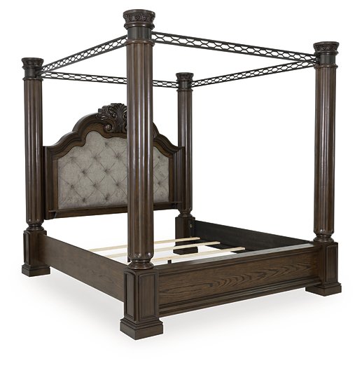Ashley Furniture Maylee Bed with upholstered headboard and wood frame, shown from an angled side view.