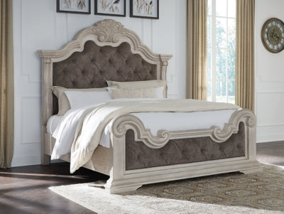 Ashley Furniture Bruchandi upholstered bed with a plush headboard and neutral fabric, shown in a close-up of the bed's side and headrest.