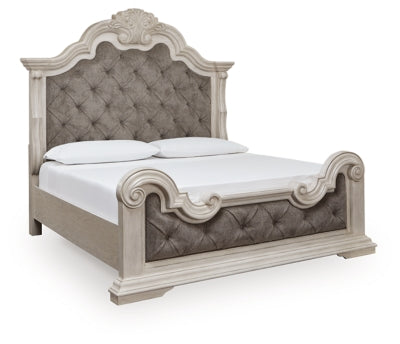 Ashley Furniture Bruchandi upholstered bed with a padded headboard and neutral fabric, shown from an angled side view.