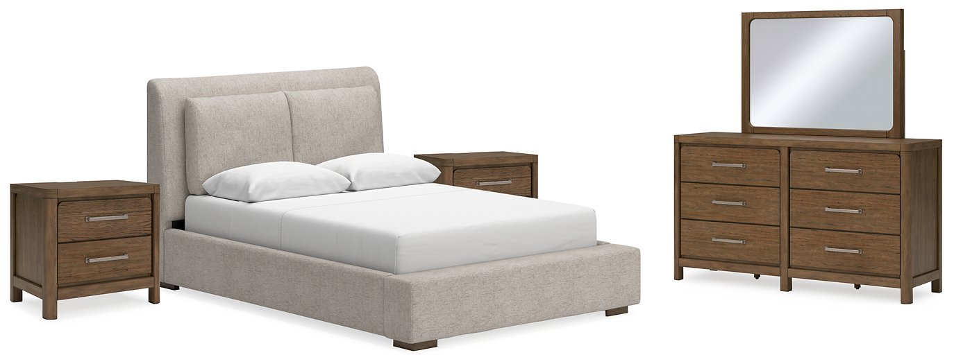Ashley Furniture Cabalynn bedroom set featuring a bed with a white upholstered headboard and matching nightstands in a cozy bedroom setting.