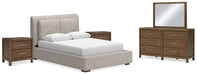 Ashley Furniture Cabalynn bedroom set featuring a bed with a white upholstered headboard and matching nightstands in a cozy bedroom setting.