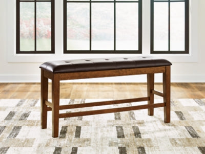 Ashley Furniture Ralene counter height dining bench with wooden legs and upholstered seat, ideal for kitchen or dining room.