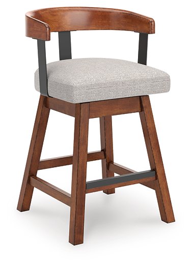 Set of two Ashley Furniture Ralene counter height barstools with wooden legs and upholstered seats, angled view.
