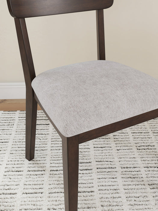 Ashley Furniture Mallenette dining chair with upholstered seat and wooden legs, shown from a detailed angle.