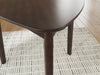 Close-up of the Ashley Furniture Mallenette dining table showing its elegant wood finish and detailed craftsmanship.