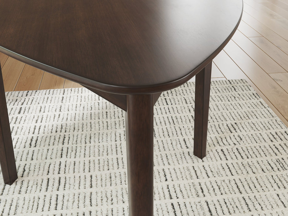 Close-up of the Ashley Furniture Mallenette dining table showing its elegant wood finish and detailed craftsmanship.