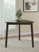Ashley Furniture Mallenette dining table with a dark wood finish and modern design, shown in a stylish dining room setting.