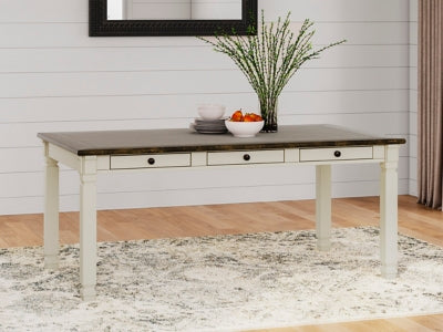 Ashley Furniture Bolanburg dining table with a rectangular wooden top and sturdy legs in a warm finish.