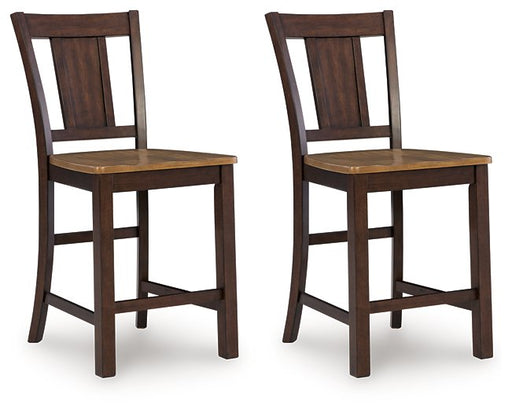 Ashley Furniture Rylandeen counter height barstool with wooden legs and a cushioned seat, shown from an angled side view.