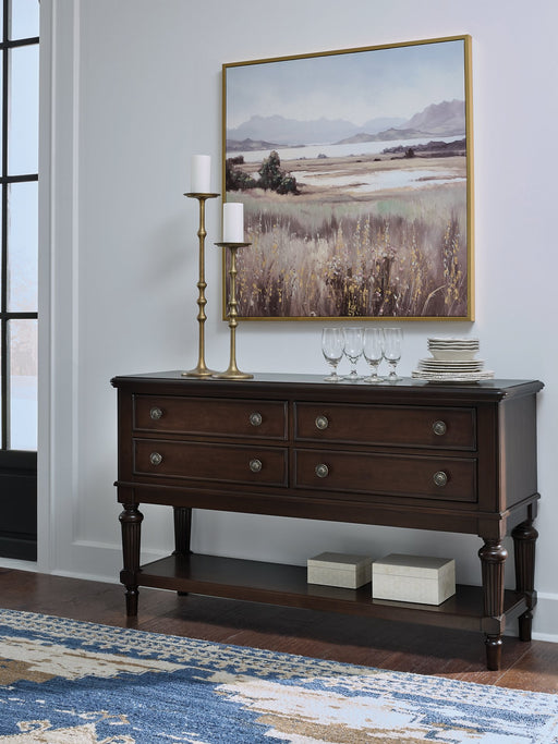 Ashley Furniture Lavinton dining server with wooden finish and multiple storage compartments, shown in a close-up image.