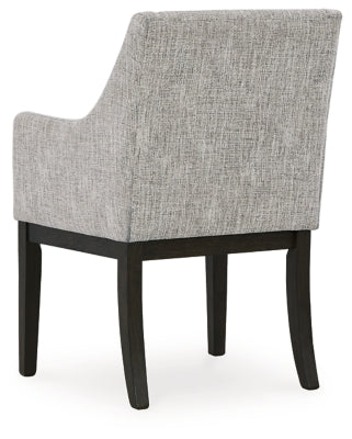 Ashley Furniture Burkhaus dining room set with a wooden table and matching chairs, shown from the back in a well-lit dining space.