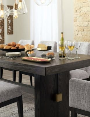 Ashley Furniture Burkhaus dining room set with a polished wooden table and matching chairs, detailed close-up of the tabletop.