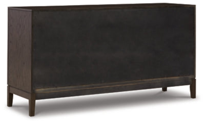 Ashley Furniture Burkhaus dining room set with a wooden table and matching chairs, shown from the back in this image.