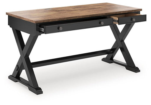 Wildenauer 60-inch Ashley Furniture home office desk with open design and angled view, featuring a spacious work surface.