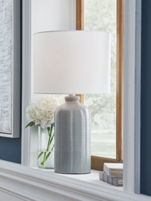 Ashley Furniture Wimlow table lamp with a sleek ceramic base and fabric shade, perfect for living room or bedside decor.