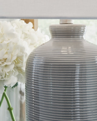Close-up of the Wimlow Table Lamp by Ashley Furniture, showcasing its detailed ceramic base and fabric lampshade.