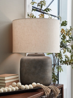 Ashley Furniture Zandophen table lamp with a sleek design, featuring a textured base and a neutral fabric lampshade.
