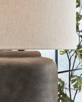 Close-up of the Zandophen Table Lamp by Ashley Furniture, showcasing its detailed base and fabric lampshade.