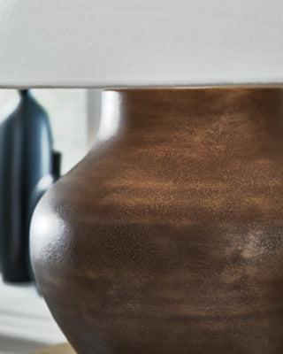 Ashley Furniture Whitham table lamp with a sleek base and fabric shade, ideal for living room or bedside decor.