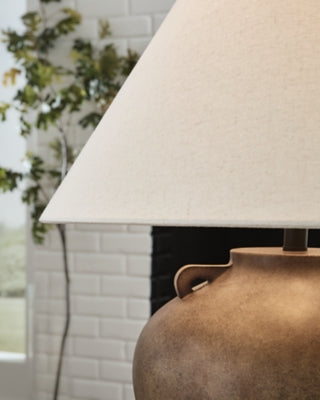 Ashley Furniture Ferrilby table lamp with a sleek base and fabric shade, perfect for enhancing home decor.