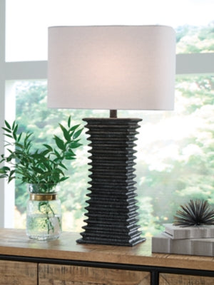 Ashley Furniture Golzar table lamp with a sleek base and fabric shade, perfect for enhancing living room or bedroom decor.