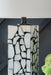 Ashley Furniture Macaria table lamp with a sleek base and fabric shade, ideal for living room or bedside lighting.