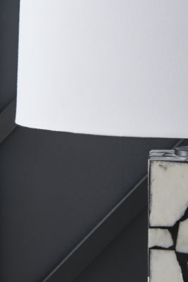 Close-up of the shade detail on the Macaria table lamp by Ashley Furniture, showcasing its elegant design and fabric texture.