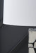 Close-up of the shade detail on the Macaria table lamp by Ashley Furniture, showcasing its elegant design and fabric texture.