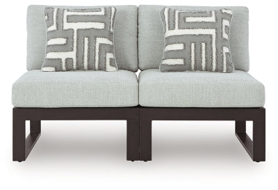 Ashley Furniture Beachloft outdoor sectional with beige cushions and woven rattan frame, ideal for patio or garden seating.