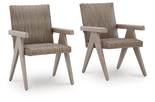 Two Ashley Furniture outdoor dining arm chairs from the Cliff Trails set, with metal frames and woven seats, shown outdoors.