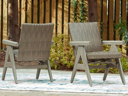 Pair of Ashley Furniture Cliff Trails outdoor rocking dining chairs with wooden frames and woven seats.