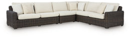 Kimora outdoor sectional by Ashley Furniture featuring plush cushions and a stylish outdoor seating arrangement.