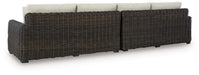 Ashley Furniture Kimora outdoor sectional with plush cushions, shown from the back in a stylish outdoor seating setup.