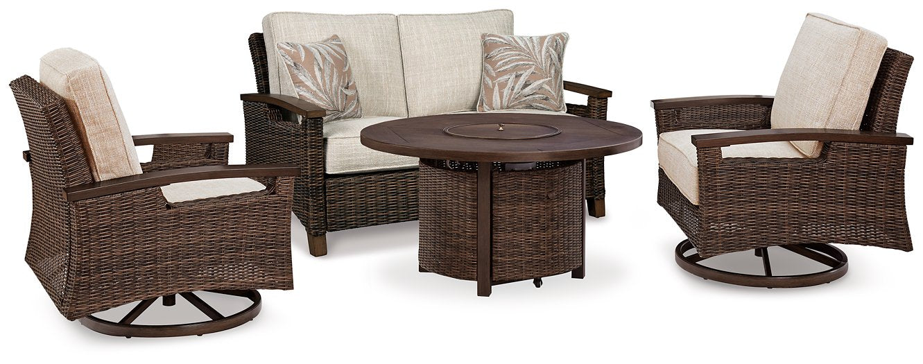 Outdoor table set with Ashley Furniture Paradise Trail loveseat, lounge chairs, and fire pit table on a patio.