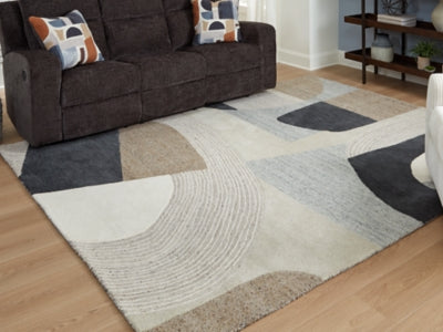 Large Ashley Furniture Edrickhill 8' x 10' rug with intricate patterns and soft texture, shown cropped in the image.