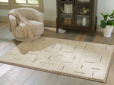 Ashley Furniture Clayman Rug, 4x3 feet, woven fabric with earthy tones, showcasing a modern geometric pattern.