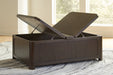 Open view of Ashley Furniture Breckington coffee table with storage, showcasing its sleek design and spacious tabletop.