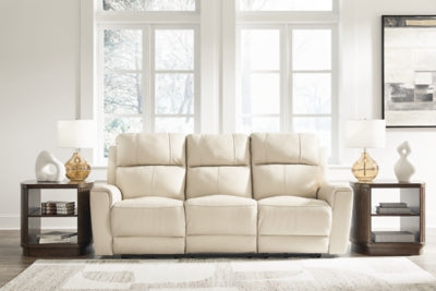 Ashley Furniture Dahlmoore power reclining sofa in dark leather with cushioned armrests and plush seating, closed position.