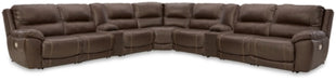Ashley Furniture Dunleith power reclining sectional with plush cushions and dark upholstery, shown in a modern living room setting.