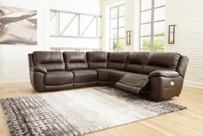 Ashley Furniture Dunleith power reclining sectional with plush cushions and a modern design, shown in a spacious living room setting.