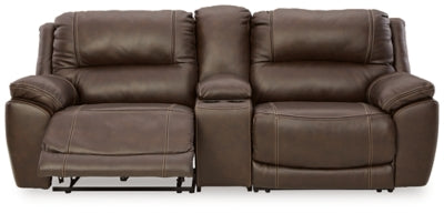 Ashley Furniture Dunleith power reclining sectional loveseat with console, showing plush cushions and reclining mechanism.