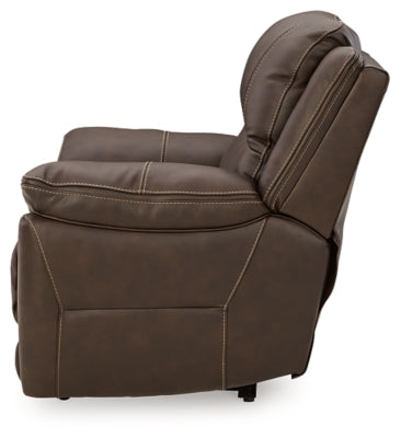 Ashley Furniture Dunleith power recliner with plush fabric and padded armrests, shown from the side in a cozy living room setting.