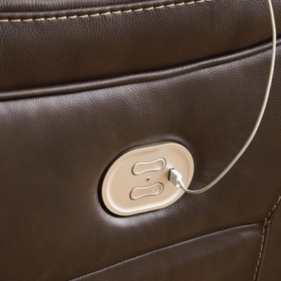 Ashley Furniture Dunleith power reclining sectional with plush cushions and dark leather upholstery, shown in a detailed view.